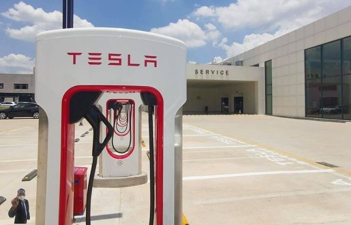 charge my Ford at a Tesla charging station